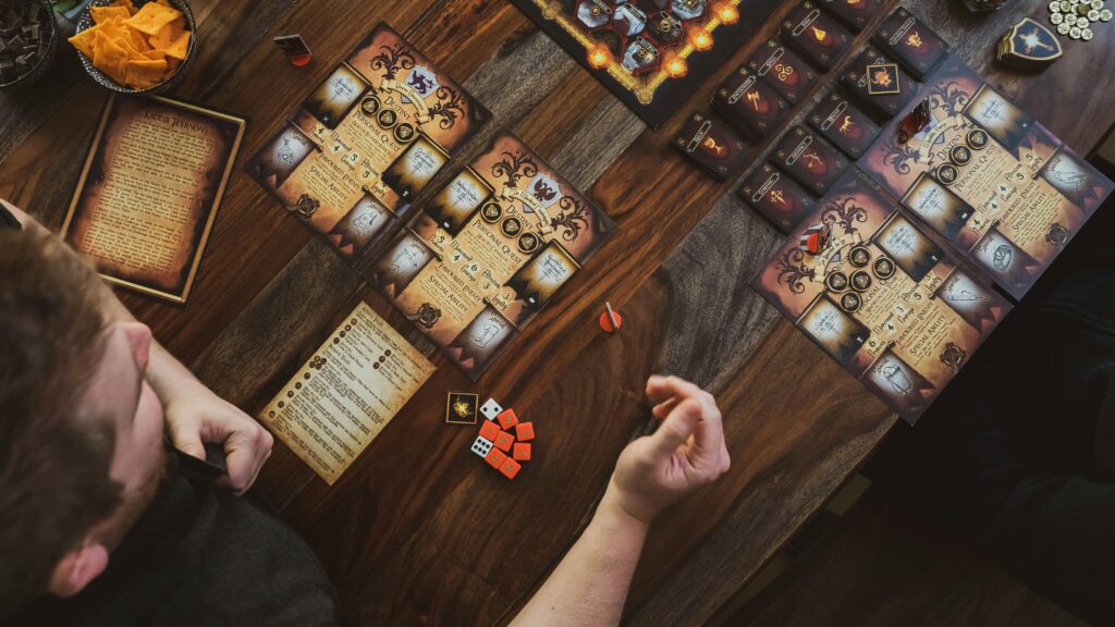 best horror board games collection showing Arkham Horror Betrayal at House on the Hill and Mansions of Madness on table
