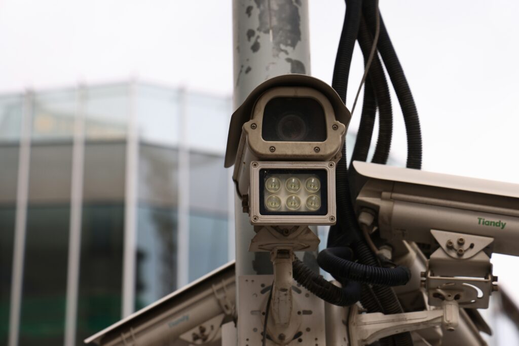 lpr camera system showing a fixed license plate recognition camera mounted on a pole representing lpr camera systems for law enforcement business and parking management including flock safety vigilant motorola and axis