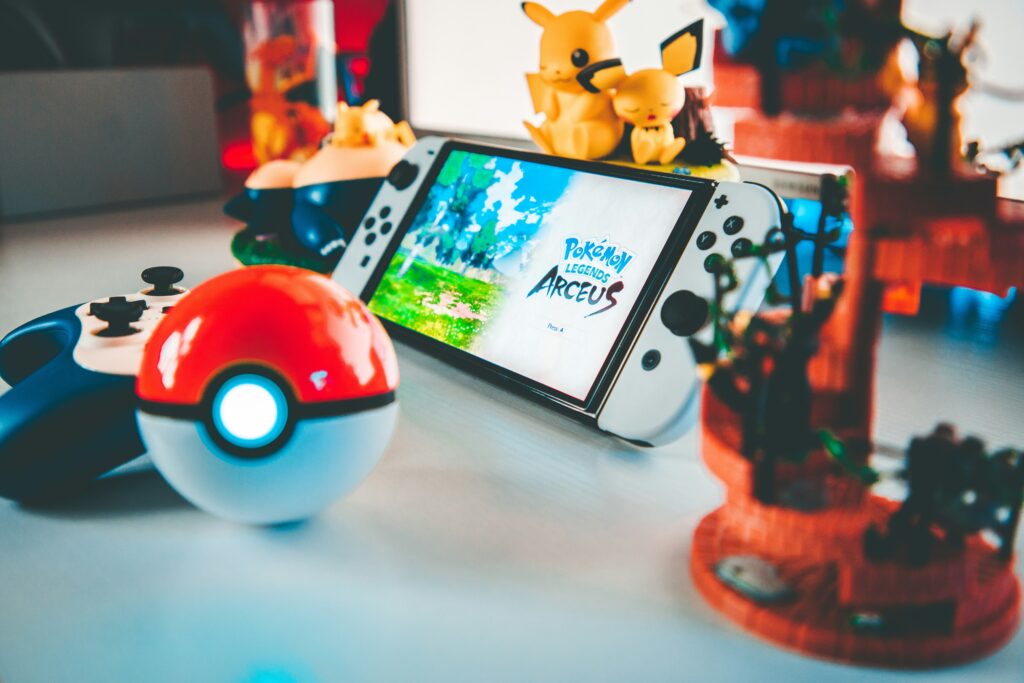 best pokemon games ranked showing Pokemon Legends Arceus gameplay with trainer catching wild Pokemon in open field representing the top ranked Switch Pokemon game in 2025