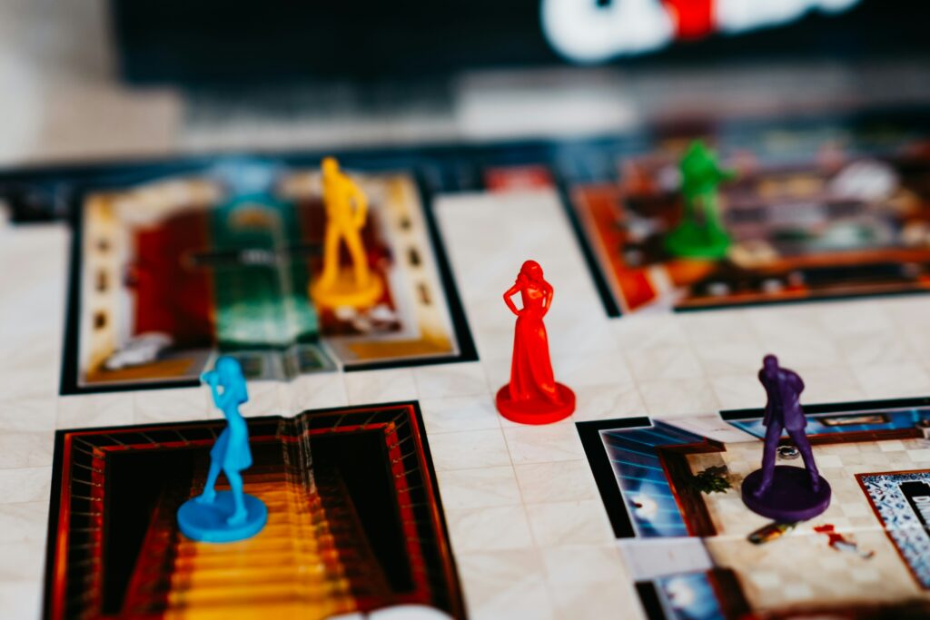best murder mystery board game selection showing Mysterium Deception and Sherlock Holmes games on table