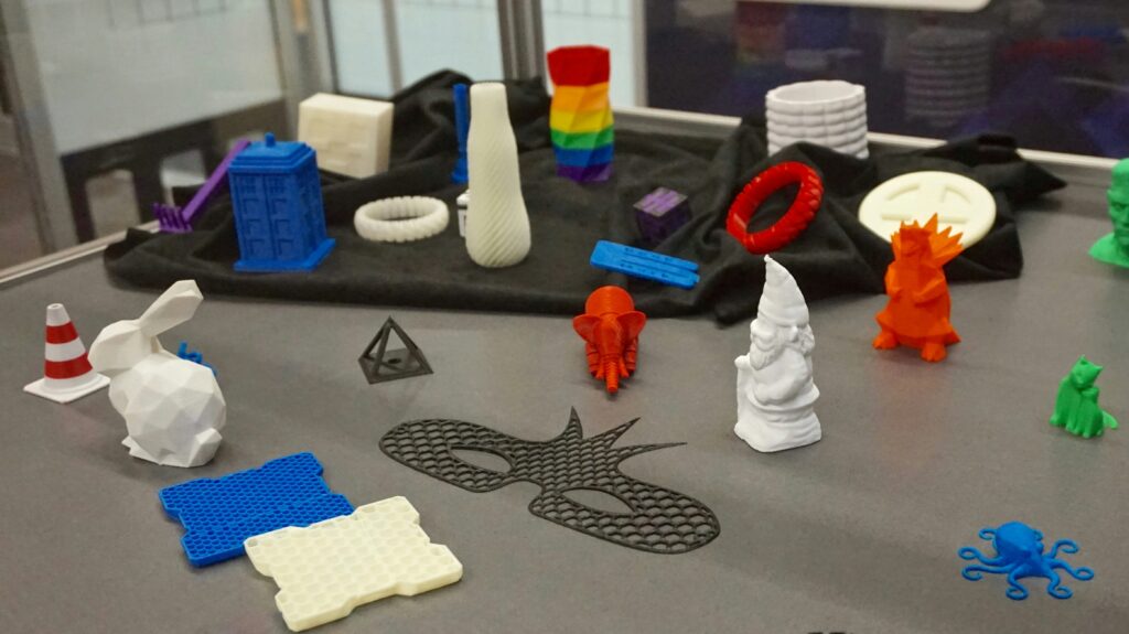 cool things to 3d print showing an articulated dragon and various 3d printed objects representing creative project ideas for a home 3d printer
