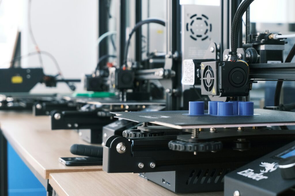 metal 3d printer showing a titanium colored 3d printed metal part representing how desktop and industrial metal 3d printing works and what it costs