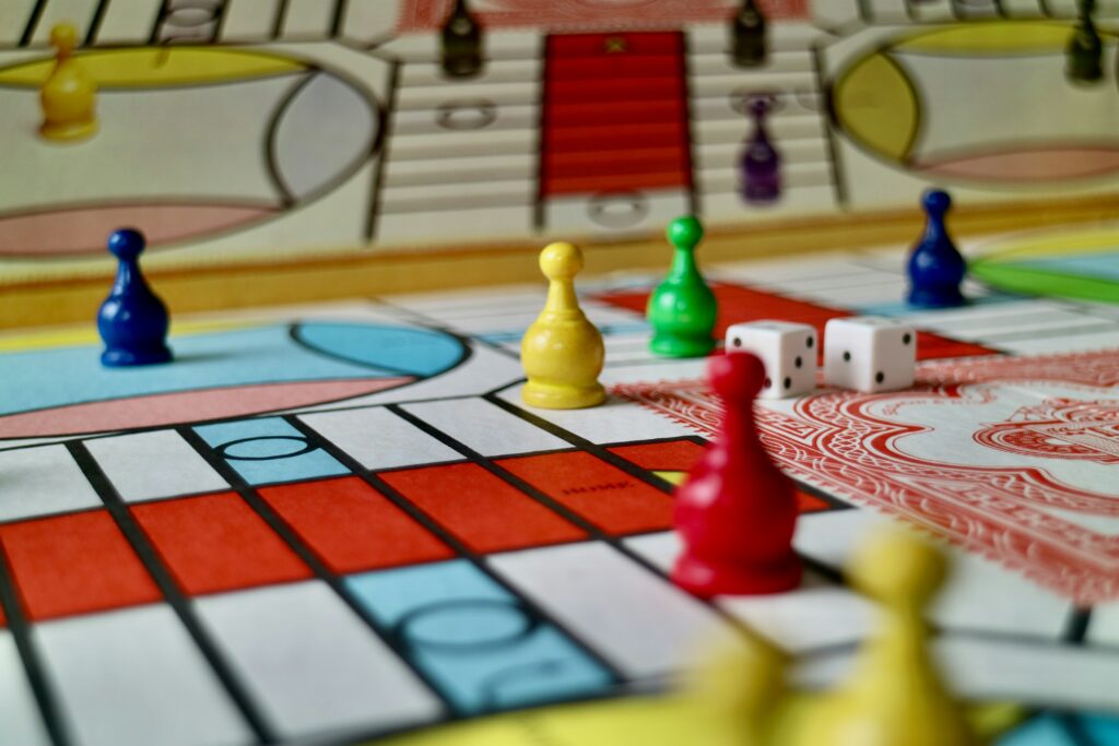 best board games for families showing Catan board game with colorful hexagonal tiles and game pieces on a table representing the top family board games for family game night and all ages