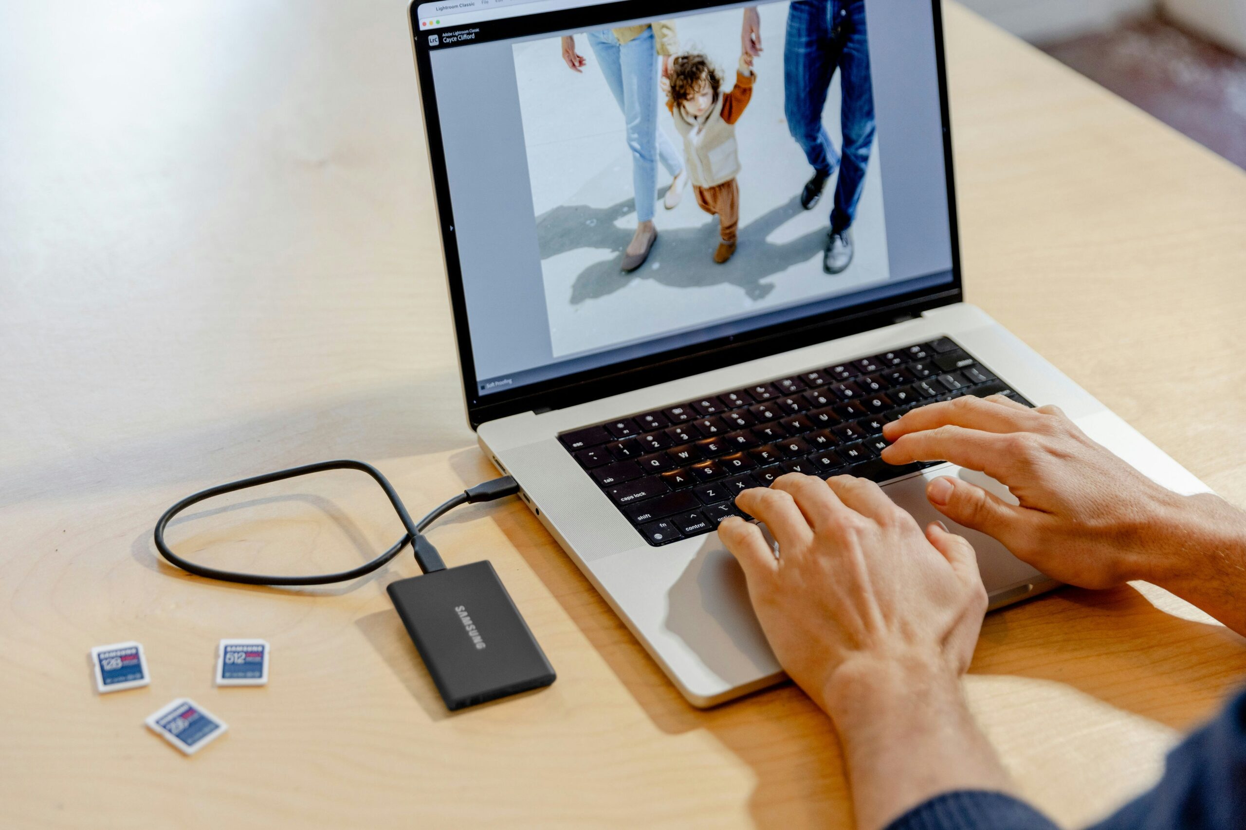 best photo backup solutions showing a smartphone automatically syncing photos to cloud storage and an external hard drive representing how to back up photos safely