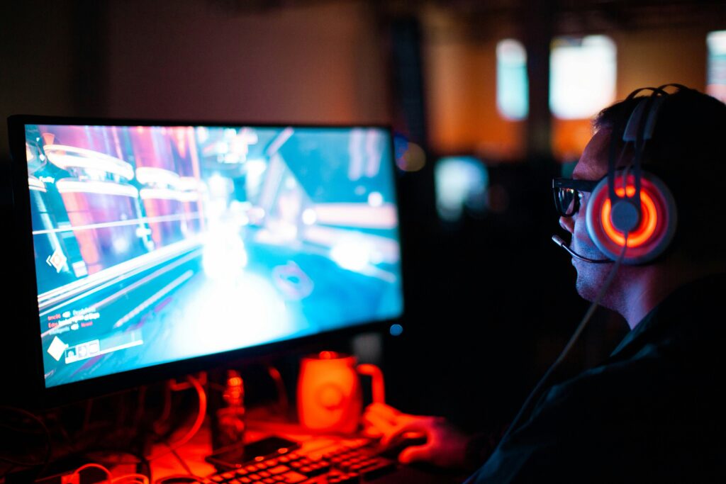 metaverse gaming platform development showing 3D virtual world with player avatars blockchain NFT assets and VR headset interface