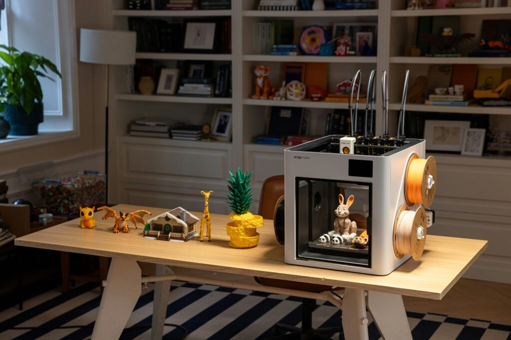 best 3d printer for beginners and kids showing a child using an enclosed desktop 3d printer representing a safe entry level setup for 2026