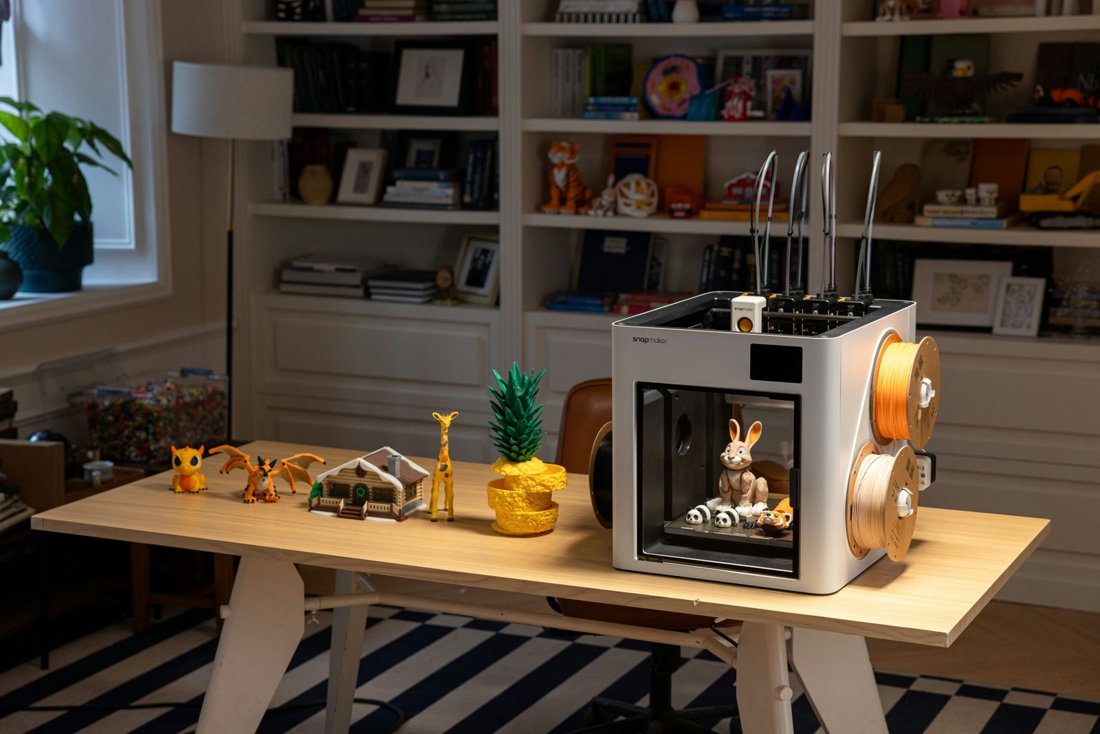 best 3d printer for beginners and kids showing a child using an enclosed desktop 3d printer representing a safe entry level setup for 2026