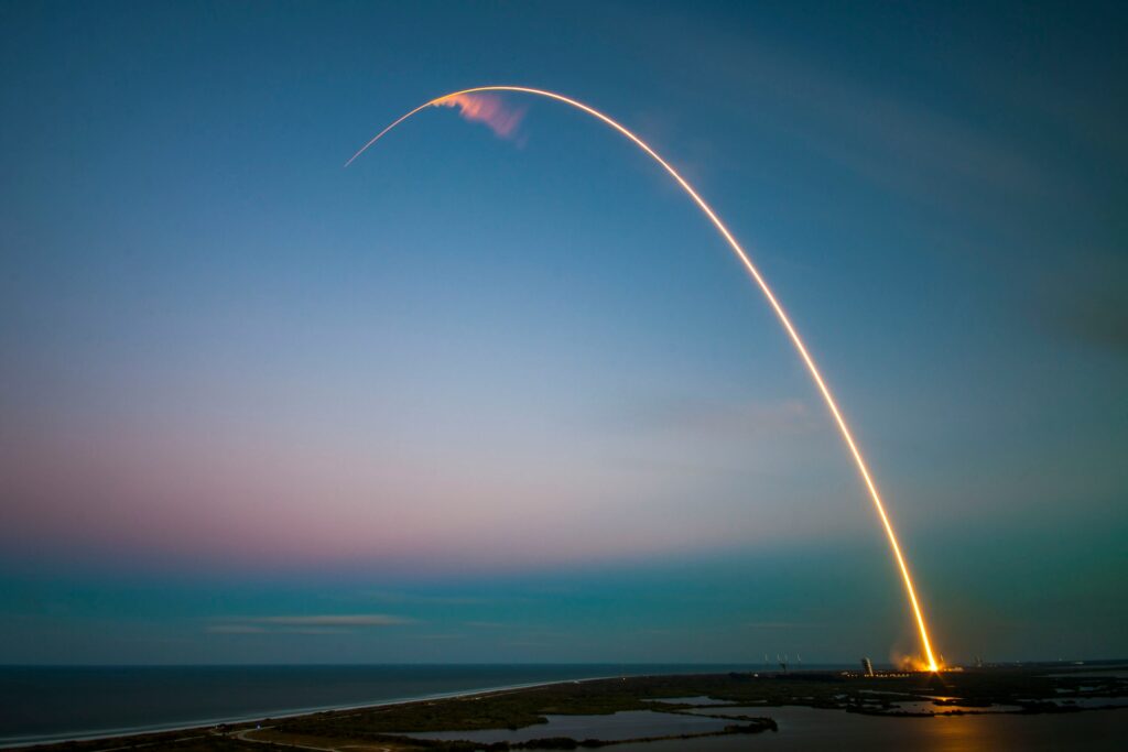 spacex spcx stock starlink ipo showing a stock ticker display with a rocket launch representing spacex going public on nasdaq in 2026