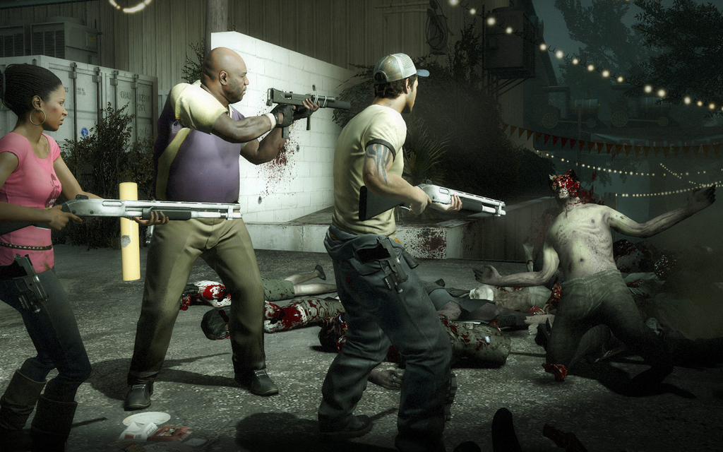 Left 4 Dead 2 four-player squad fighting a zombie horde with shotguns