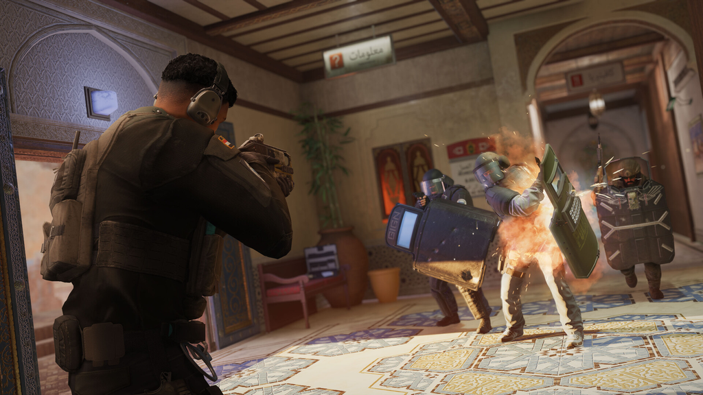 Rainbow Six Siege operators breaching a room with shield and flashbang during a tactical match